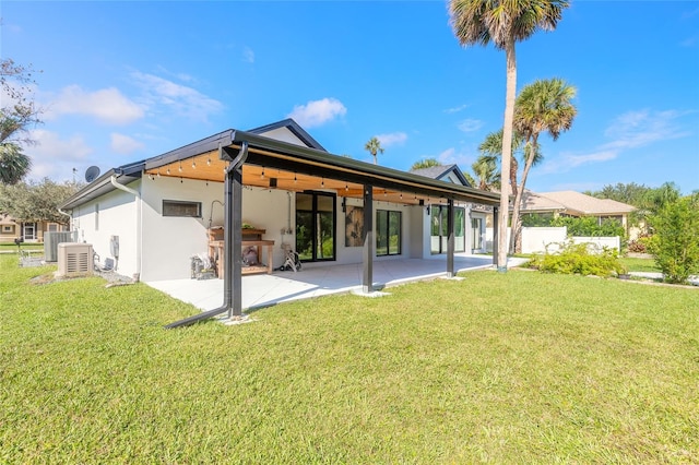 rear view of property featuring a patio area and a lawn