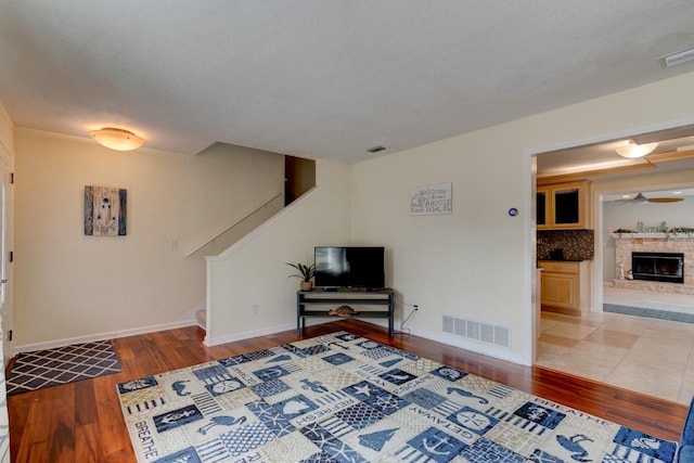 living room with wood-type flooring and ceiling fan