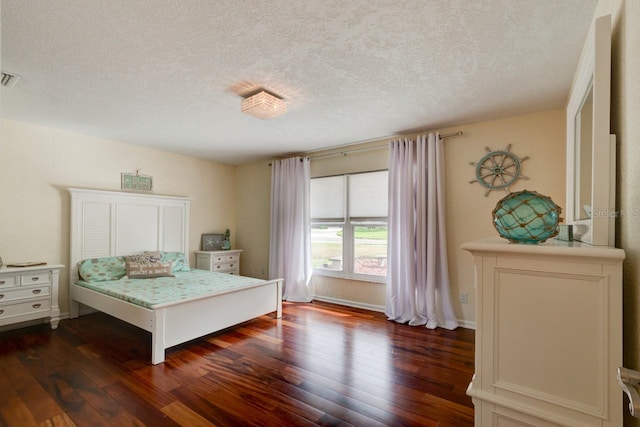 bedroom featuring dark hardwood / wood-style floors and a textured ceiling