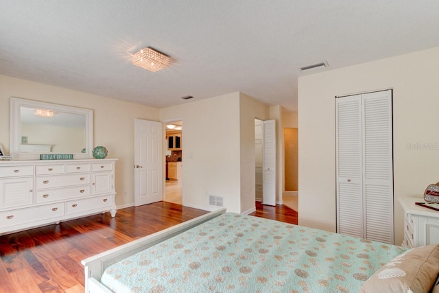 bedroom featuring wood-type flooring and a closet