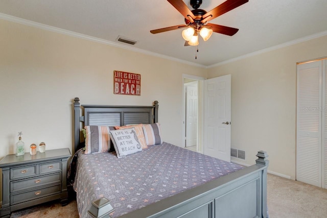 bedroom with crown molding, ceiling fan, a closet, and light carpet