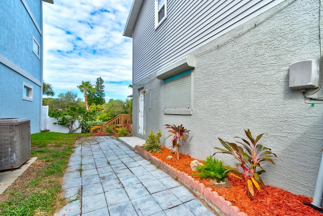 view of home's exterior featuring a patio area and central air condition unit