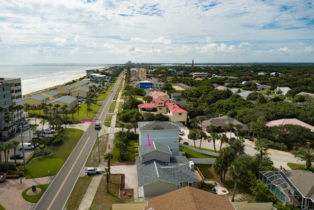 birds eye view of property with a view of the beach and a water view