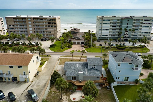 drone / aerial view featuring a water view and a beach view