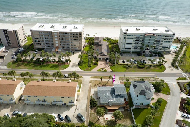 bird's eye view featuring a water view and a beach view