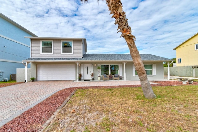 view of front facade with a garage and a front yard