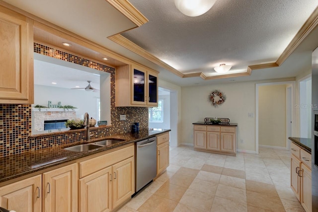 kitchen with stainless steel dishwasher, a raised ceiling, sink, and light brown cabinets