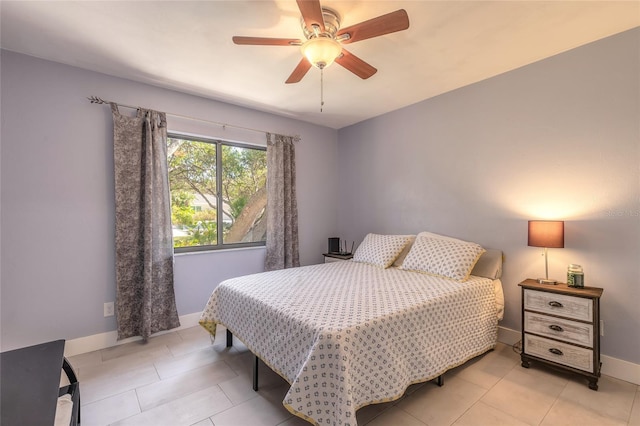 tiled bedroom featuring ceiling fan