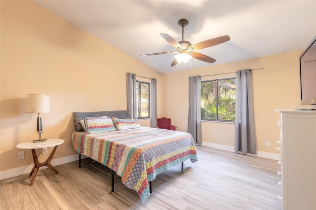 bedroom with light hardwood / wood-style flooring, ceiling fan, and lofted ceiling