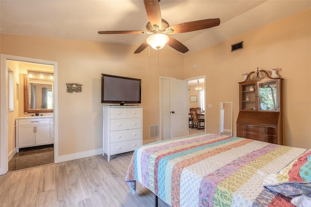 bedroom featuring ceiling fan, light hardwood / wood-style floors, and ensuite bathroom