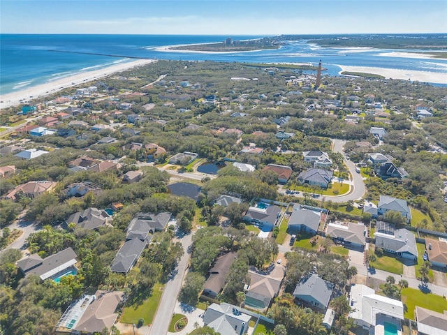 drone / aerial view featuring a water view and a view of the beach