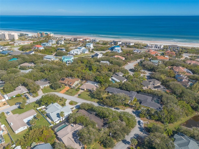 drone / aerial view featuring a beach view and a water view