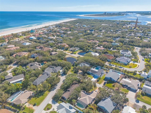 drone / aerial view with a beach view and a water view