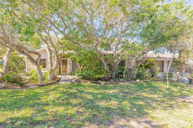 obstructed view of property featuring a front lawn