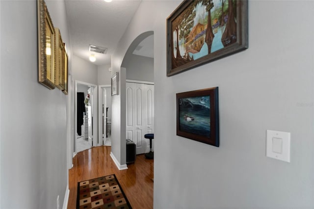 hall with hardwood / wood-style flooring