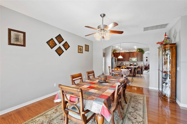 dining room with ceiling fan and light wood-type flooring