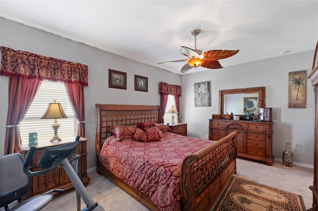 bedroom featuring light colored carpet and ceiling fan