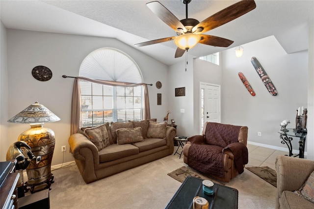 living room with ceiling fan, light colored carpet, and vaulted ceiling