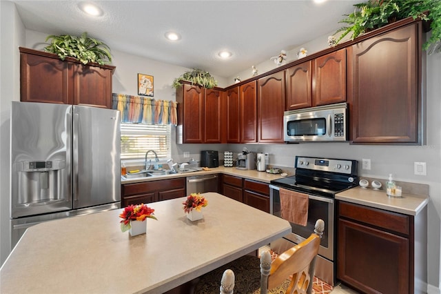 kitchen featuring a textured ceiling, sink, and appliances with stainless steel finishes