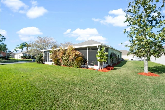 exterior space with a lawn and a sunroom