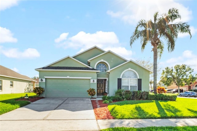 view of front of house featuring a front lawn and a garage