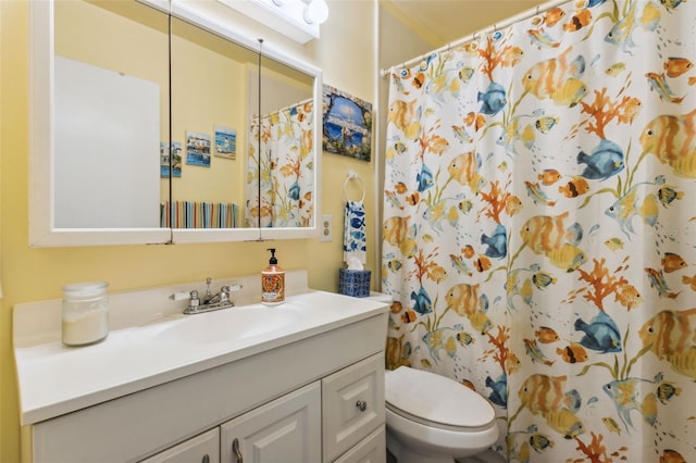 bathroom with toilet, vanity, and a shower with curtain