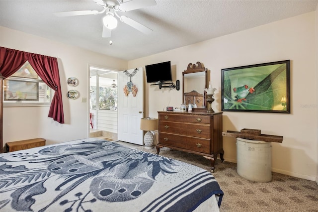 bedroom featuring ceiling fan, carpet floors, and a textured ceiling