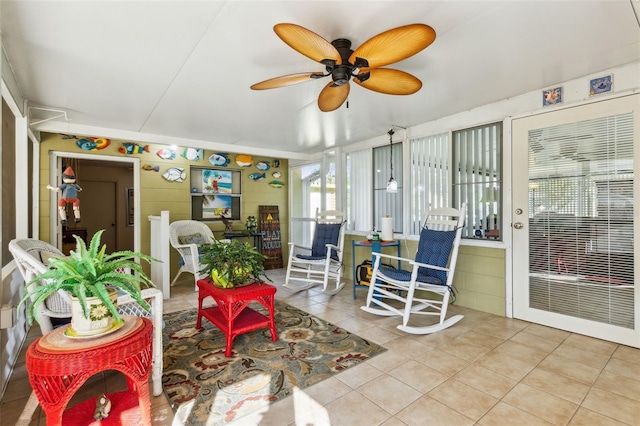 sunroom featuring ceiling fan