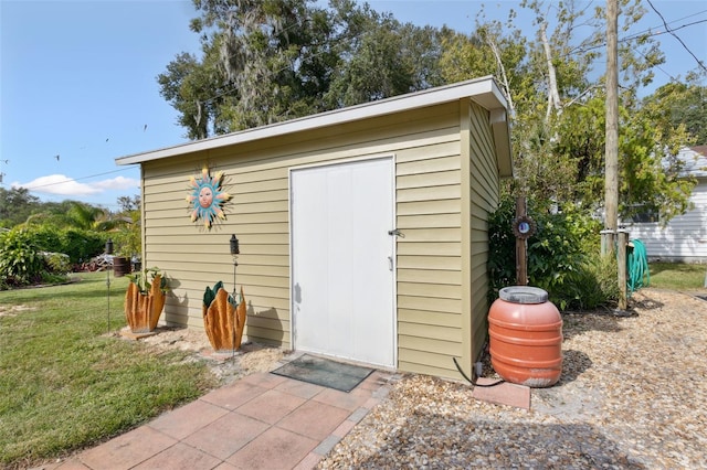 view of outbuilding with a yard