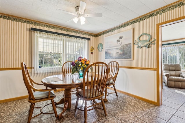 dining area with ceiling fan, crown molding, and plenty of natural light