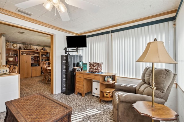 living room with ceiling fan and ornamental molding