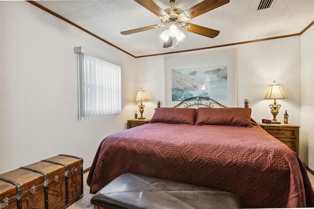 carpeted bedroom featuring ceiling fan and crown molding