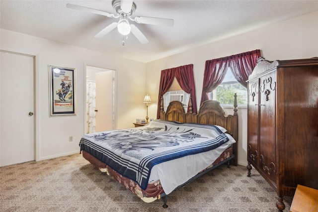 bedroom featuring light carpet, ensuite bathroom, ceiling fan, cooling unit, and a textured ceiling