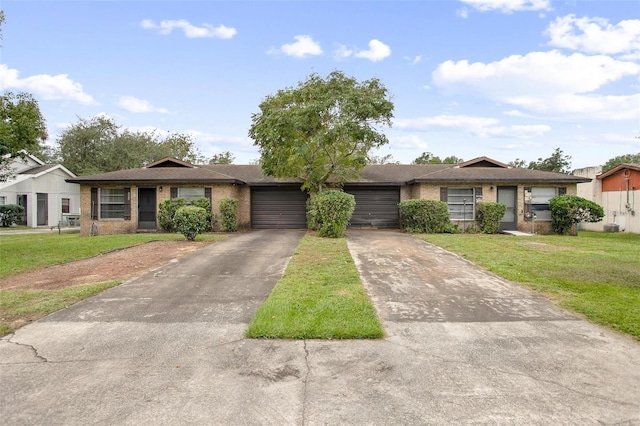 ranch-style home featuring a front lawn and a garage