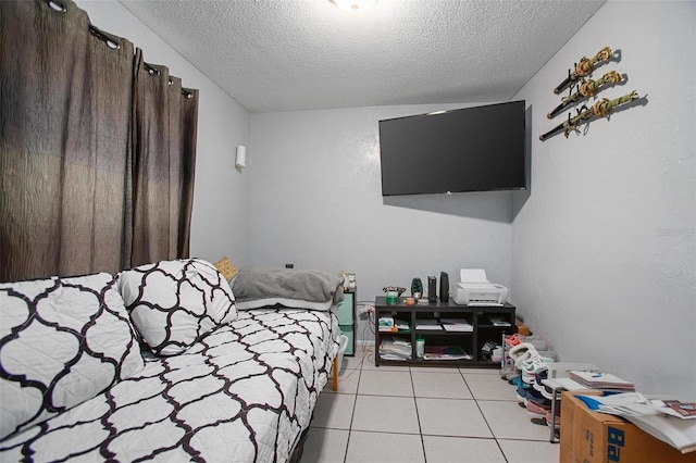 bedroom with light tile patterned floors and a textured ceiling