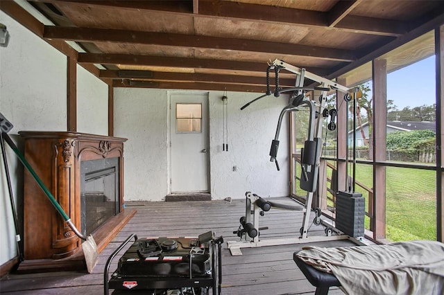 1571 S Boundary St, Deland, FL 32720 - workout room featuring a textured wall, hardwood / wood-style flooring, and a glass covered fireplace