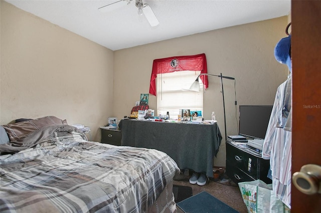 bedroom featuring ceiling fan and carpet