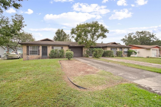 1571 S Boundary St, Deland, FL 32720 - single story home with asphalt driveway, a garage, brick siding, and a front lawn