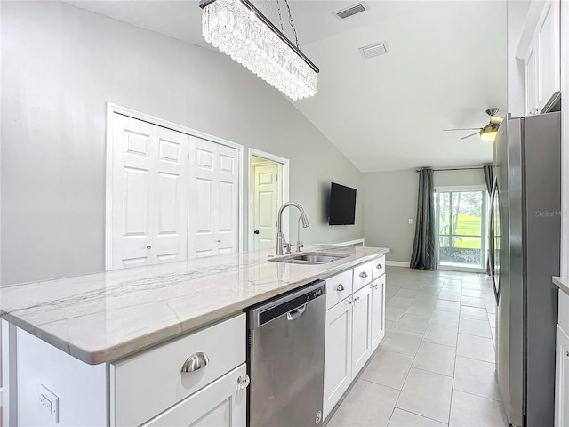 kitchen featuring lofted ceiling, white cabinetry, sink, and appliances with stainless steel finishes