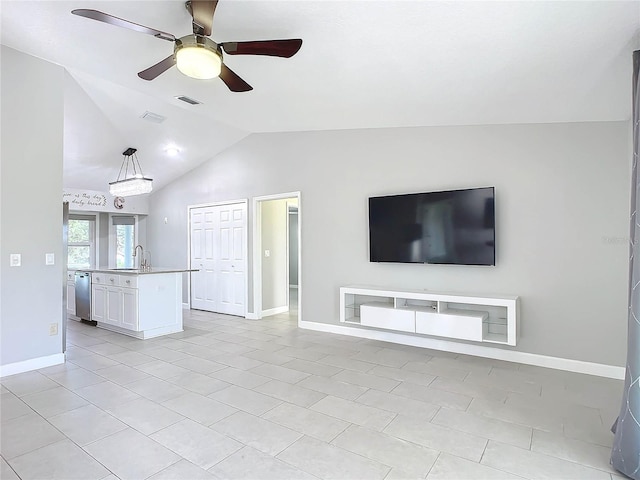 unfurnished living room with ceiling fan, light tile patterned flooring, sink, and vaulted ceiling