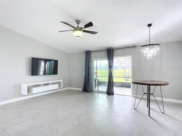 unfurnished living room with light tile patterned floors, ceiling fan with notable chandelier, and vaulted ceiling