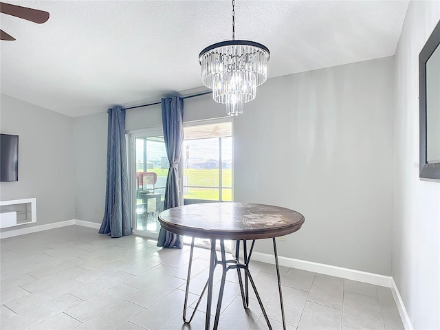 dining space with a chandelier, light tile patterned floors, and a textured ceiling