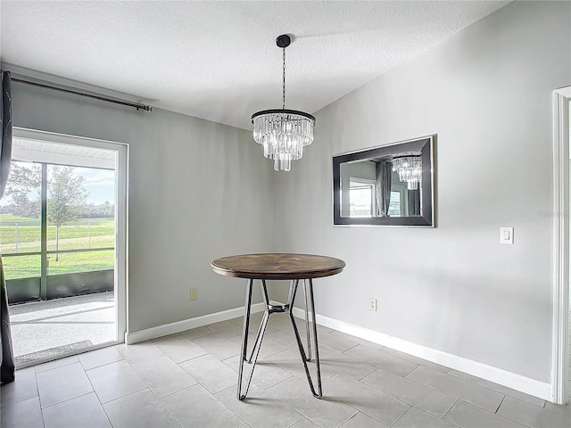 unfurnished dining area with a textured ceiling, a notable chandelier, and light tile patterned flooring