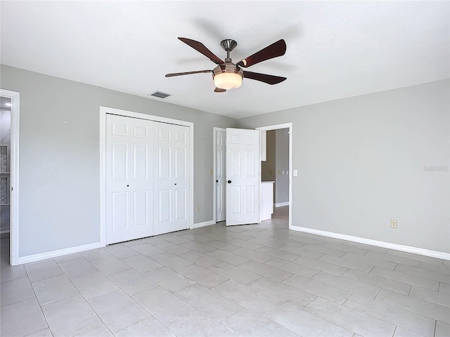 unfurnished bedroom with light tile patterned floors and ceiling fan