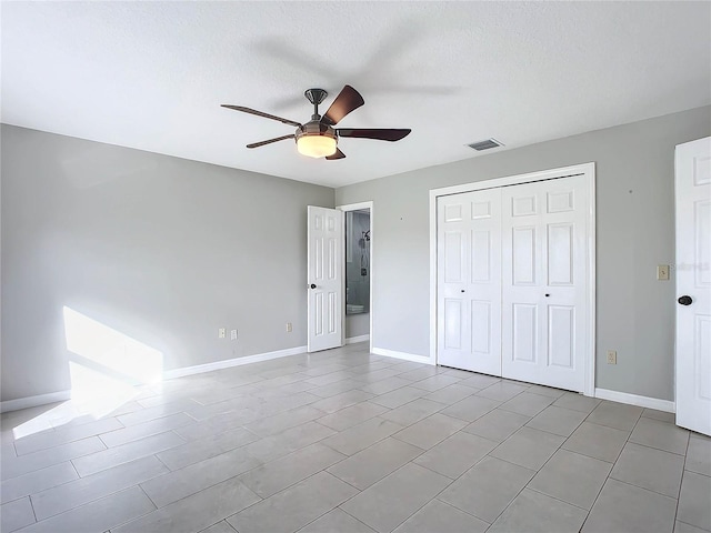 unfurnished bedroom featuring ceiling fan, a textured ceiling, and a closet