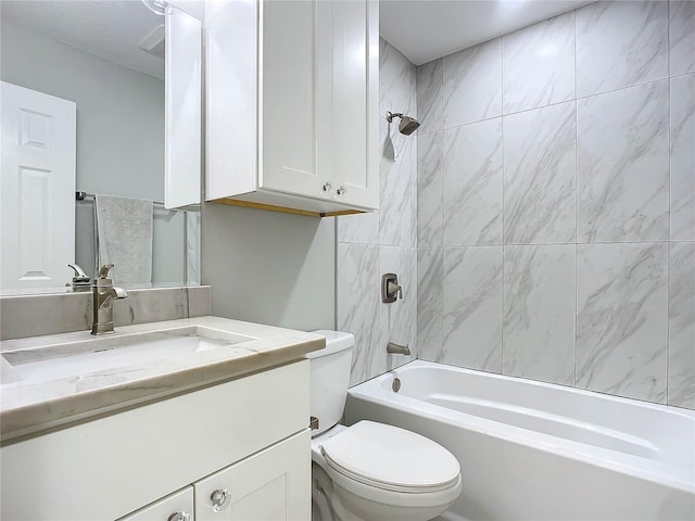 full bathroom with vanity, toilet, and tiled shower / bath