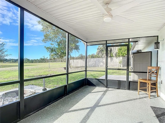 unfurnished sunroom with ceiling fan