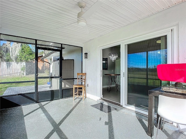 sunroom / solarium featuring ceiling fan