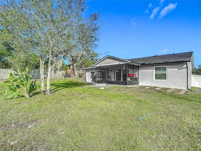 back of house featuring a sunroom and a yard