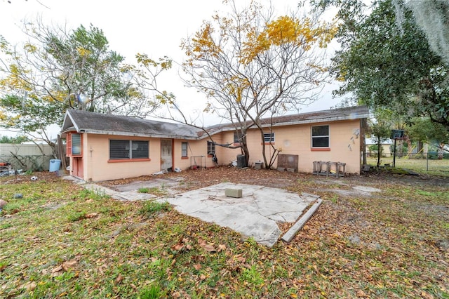 rear view of house with central AC and a patio